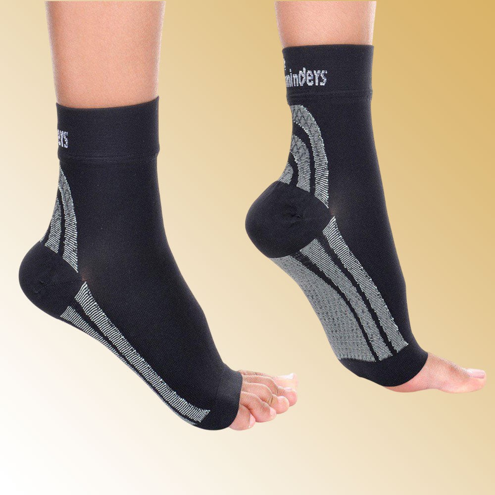 Black ankle support sleeves with visible branding on a beige background